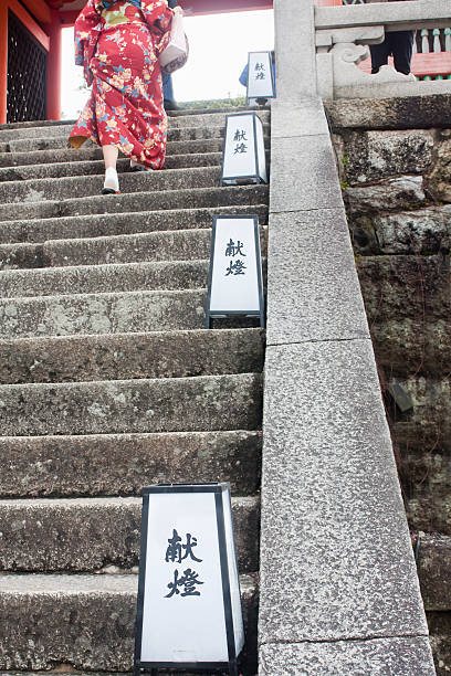 Lady wearing kimono, climbing a stone staircase. Kyoto, Japan- Mars 15, 2016: rear view from below of a lady wearing colorful kimono, climbing a stone staircase, Kyoto Japan. japan women human foot japanese culture stock pictures, royalty-free photos & images