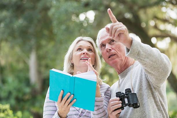 Senior couple in the woods birdwatching