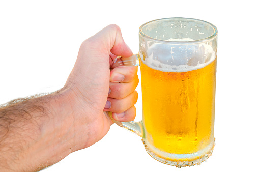 Young man hand holding a refreshing beer isolated