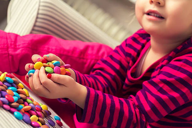 istock Adorable preschool girl playing with sweets 531469238