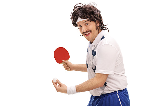 Young retro man playing table tennis and looking at the camera isolated on white background