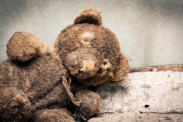 istock Old teddy bear abandoned piles of paper 531470626