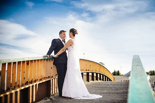 Happy newlyweds on the bridge in park