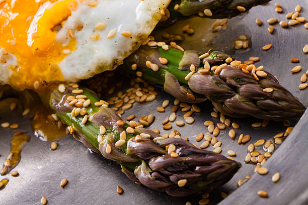 istock Asparagus with roasted sesame and fried egg. 531472416