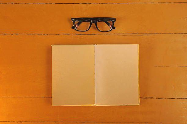 istock vintage note book and glasses on wooden table 531473456