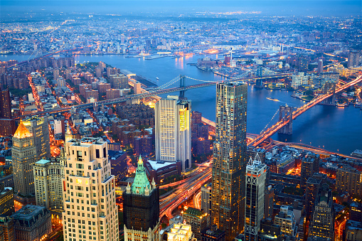 Aerial view of New York City skyline with Three Bridges at dusk