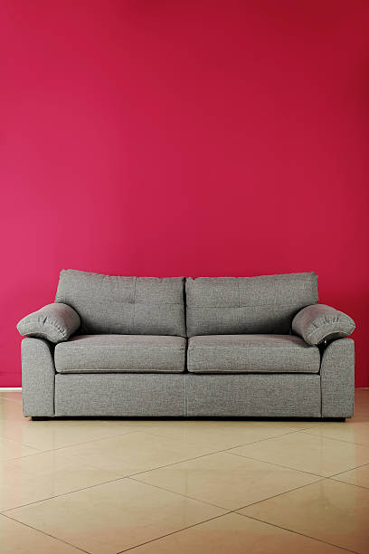 istock Grey sofa on a pink background, close up 531474248