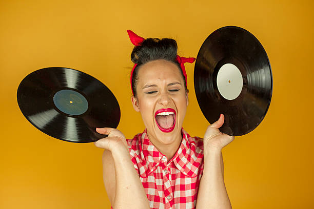 Close up portrait pin up girl with old vinil records stock photo