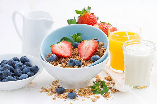 istock healthy breakfast - granola, fresh berries and milk 531474524