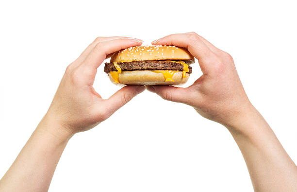 istock Hamburger sandwich in female hands isolated on white 531475556