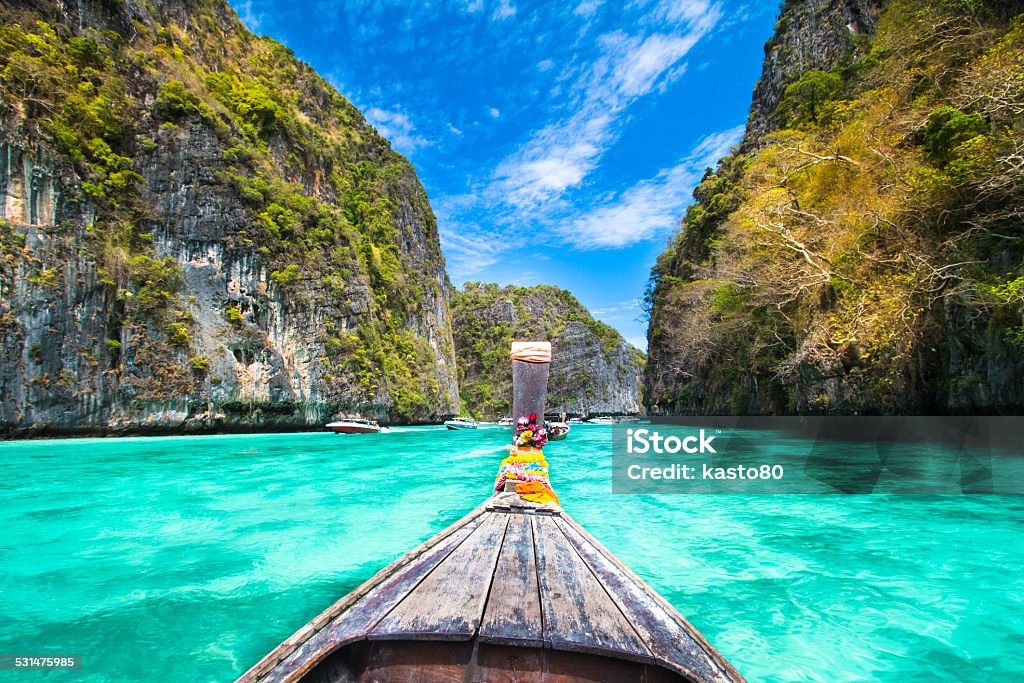 Wooden boat on Phi-Phi island, Thailand. Traditional wooden  boat in a picture perfect tropical bay on Koh Phi Phi Island, Thailand, Asia. Island Stock Photo