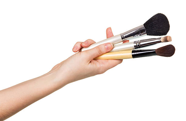 istock Cosmetic Makeup Brush in  female hand isolated on white background 531476734