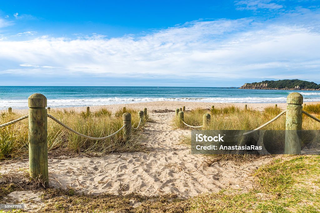 Entrance to the beach in sunny day The sandy beach in Maunganui, Bay of Planty, New Zealand Beach Stock Photo