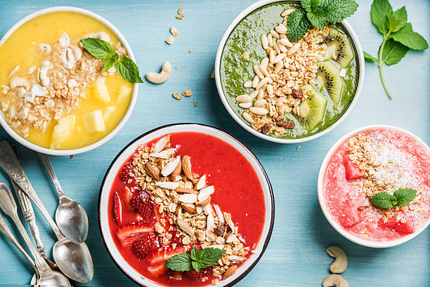 istock Healthy summer breakfast concept. Colorful fruit smoothie bowls on turquoise 531477566