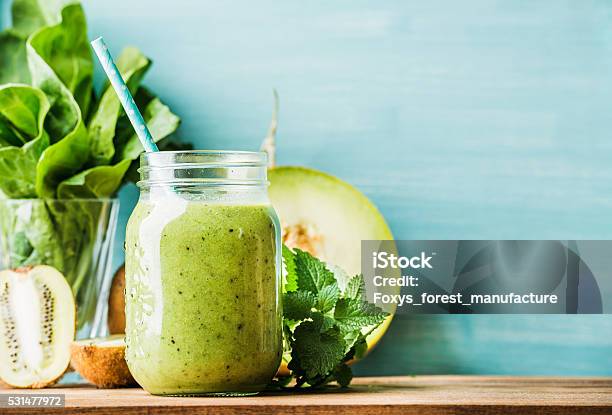 Freshly Blended Green Fruit Smoothie In Glass Jar With Straw Stock Photo - Download Image Now