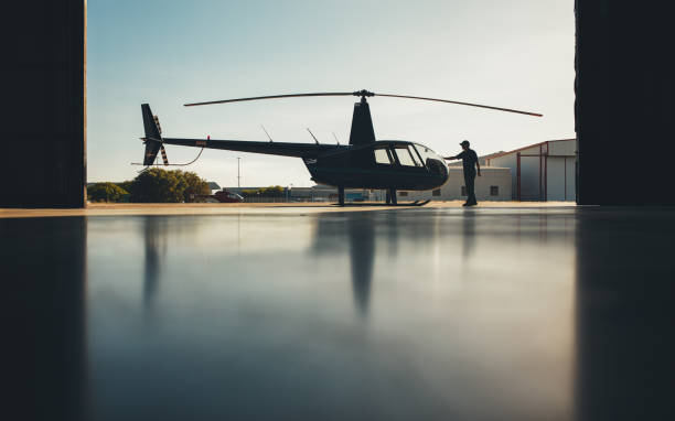 istock Silhouette of helicopter in the hangar with a pilot 531478378