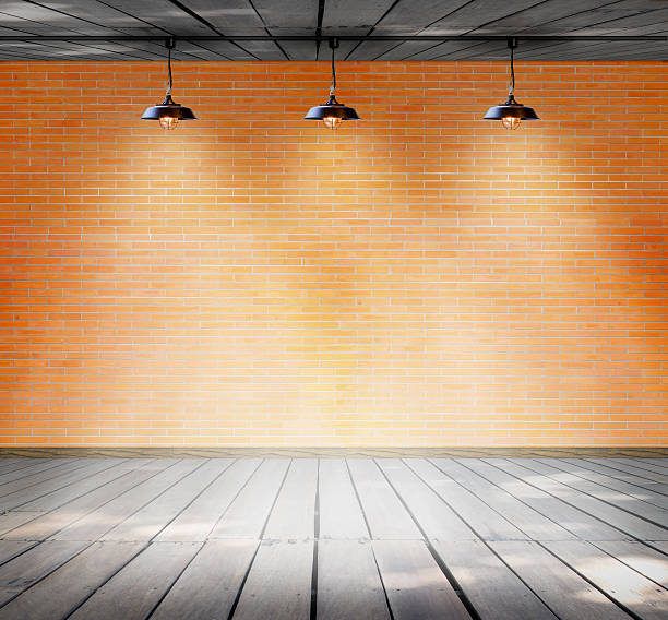 istock Lamp at brick wall background with ground wood 531478761