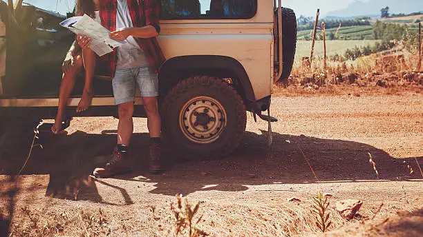 Photo of Couple with a map on road trip