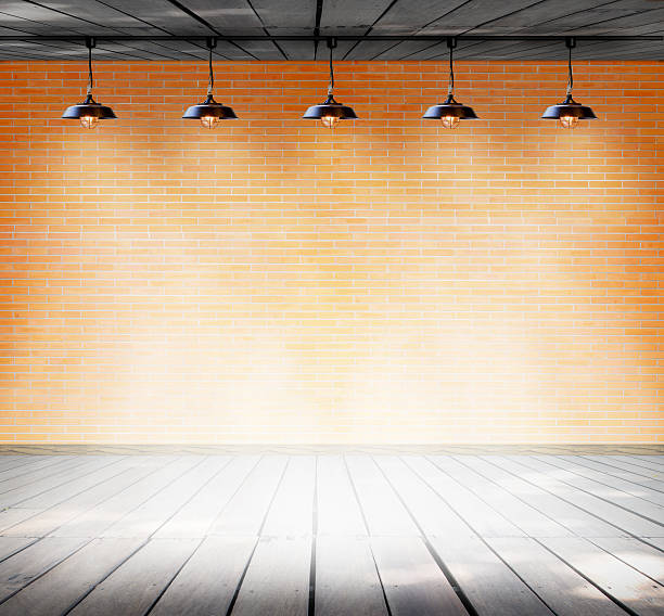 istock Lamp at brick wall background with ground wood 531478795