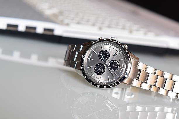 Luxury Wrist watch on desk Luxury Wrist watch on work desk tacheometer stock pictures, royalty-free photos & images