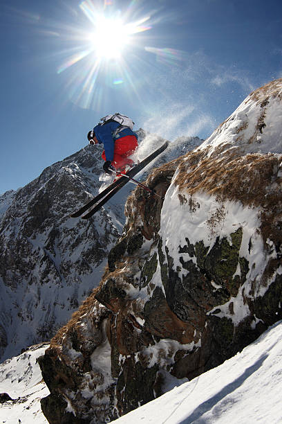 istock Snow Skier Jumping off Rock 531479267