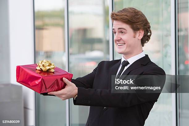 Man With Gift In His Hand Stock Photo - Download Image Now - 2015, Adult, Adults Only