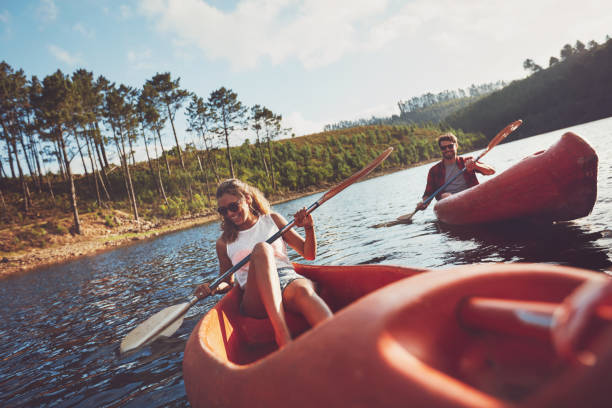 istock Happy young couple canoeing on lake 531480094