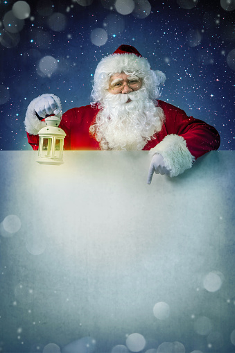 Santa Claus with lantern on billboard