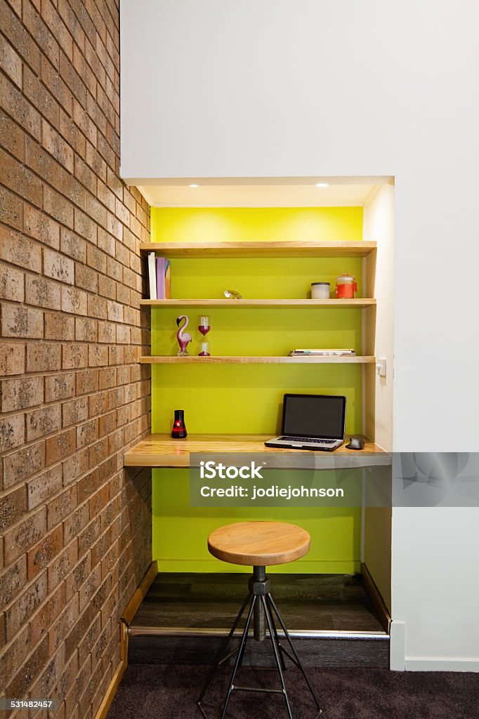 Lime green feature wall study nook in living room Lime green feature wall study nook in contemporary living room Home Office Stock Photo