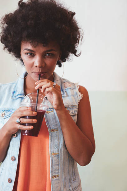 istock Young african woman drinking fresh fruit juice 531482590