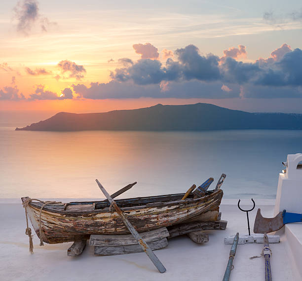 Sunset Santorini old boat in Oia on Greece