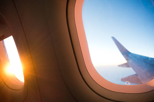 istock Sunset and Wing Through the Airplane Window 531484160