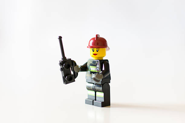 Florence, Italy - May 12, 2016: Lego Minifigure Female Head is a firefighter, she's wearing red cup and she's smiling with red lipstick