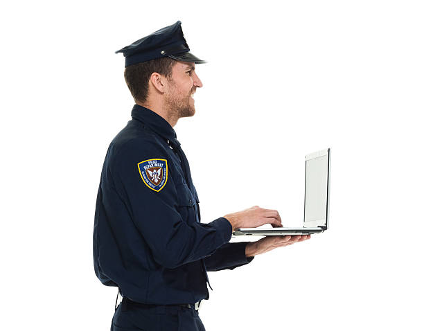 istock Smiling police working on laptop 531485552