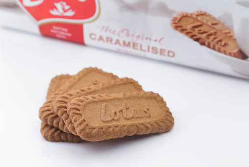 Istanbul, Turkey - October 31, 2014: Package and pieces of Lotus Biscoff Original Caramelised Biscuit. Lotus Bakeries is a Belgian company initially specialized the biscuits