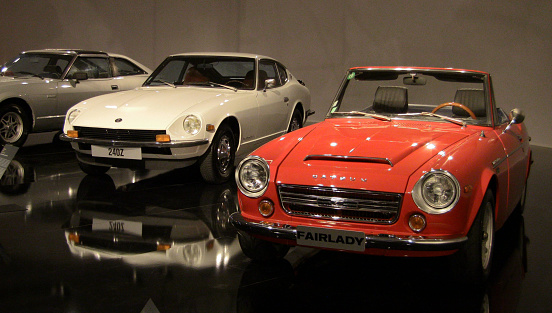 Paris, France, October 1st, 2010: The presentation of classic Datsun 2000 Fairlady and Datsun 240Z (successor) on the Paris Motor Show. The roadster on the right is one of the most beautiful Japanese classic car with 60s. This roadster was produced between 1967-1970. The coupe model on the left (240Z) was one of the most exciting sport cars in 70s. This coupe was produced between 1969-1978.
