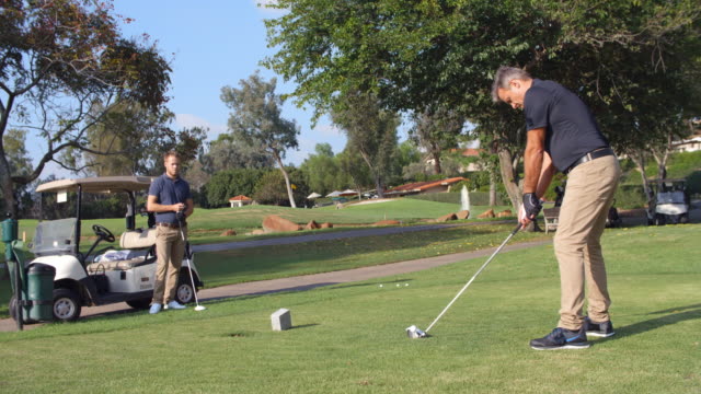 Slow Motion Shot Of Male Golfer Playing Tee Shot
