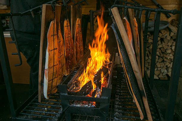 istock smoking cooking salmon fish by the fire at brussel belgium 531503431
