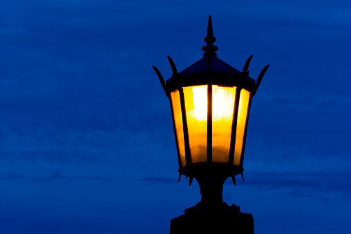 Solitary street lamp burns at dusk