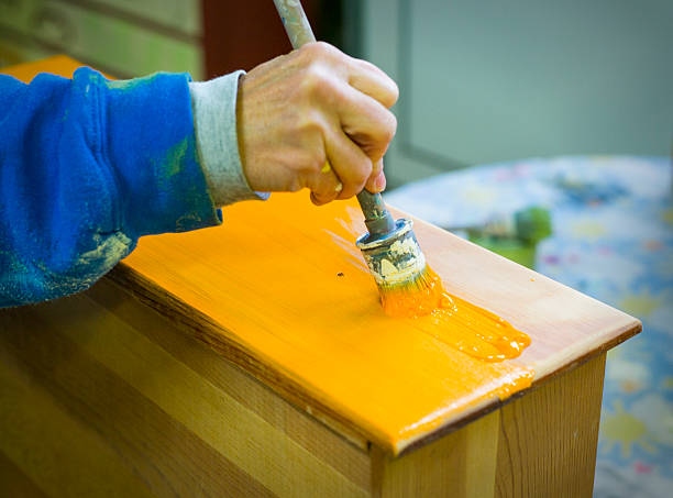 Vibrant paint going on a resotred piece of furniture stock photo