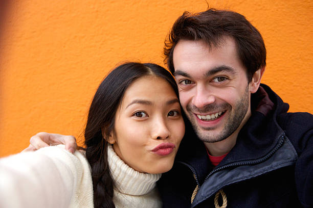 istock Happy young couple smiling and taking selfie 531505323