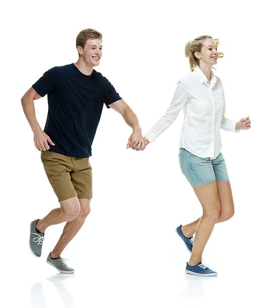 istock Cheerful couple holding hands & running 531505709