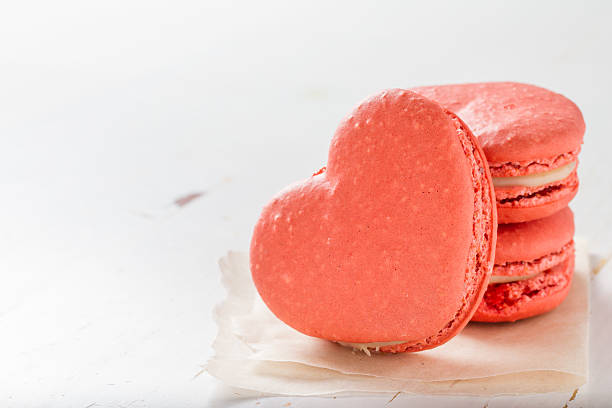 istock Pink heart shaped macaroons on white paper 531507969