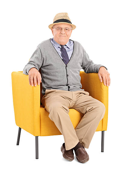 istock Senior sitting in a modern armchair and looking at camera 531508205