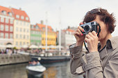 Tourist taking photos in Nyhavn, Copenhagen.