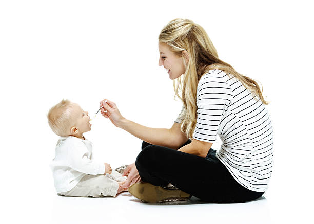 istock Cheerful woman feeding her baby 531520137