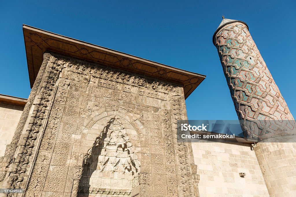 Yakutiye Medresse Erzurum Turkey Yakutiye Medresse Erzurum Turkey  This structure was build by Cemaleddin Hodja Yakut on behalf of Gazan Han and Bolugan Hatun in 1310 during the Inhansid emperor perod. PuÛil rooms and classrooms are located on either side of court. The surface of the room entrances have rosettas including different geomatrical and botanical decorations. The panels thats consist of eagle, life tree and lion motifs are located at both sides of the portal. There is a brick decoration on the minaret body in the south-west corner. The tomb is next to the uÛÛer hall in the east. Today the Medresse in used is Turkish and Islamic works and Etnographic museum where various etnographical objects of the region are exhibited. 2015 Stock Photo