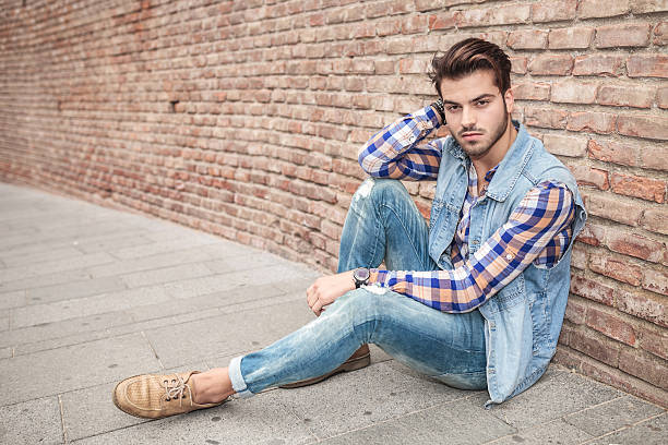 istock handsome man resting on the sidewalk, leaning against a wall 531521079