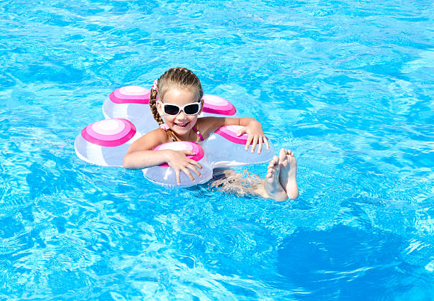 istock Smiling little girl in swimming pool 531521147