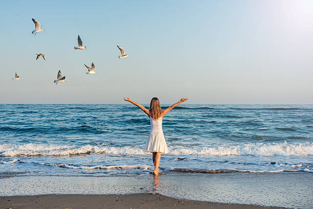 istock Girl standing at the beach 531523413